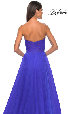 Woman in the La Femme Strapless Long Prom Ball Gown 31997, shown from the back in royal blue. The dress features a strapless neckline, subtle sparkles, and an elegant a-line silhouette against a white background.