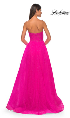 A woman faces away in the La Femme Strapless Long Prom Ball Gown 31997, a bright pink, sparkly, strapless design. The La Femme logo is shown in the top right corner.