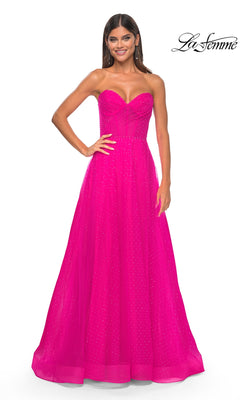 A woman wears the La Femme Strapless Long Prom Ball Gown 31997 in bright pink, featuring a fitted bodice, flared A-line skirt, and subtle sparkle. "La Femme" logo appears in the top right corner.