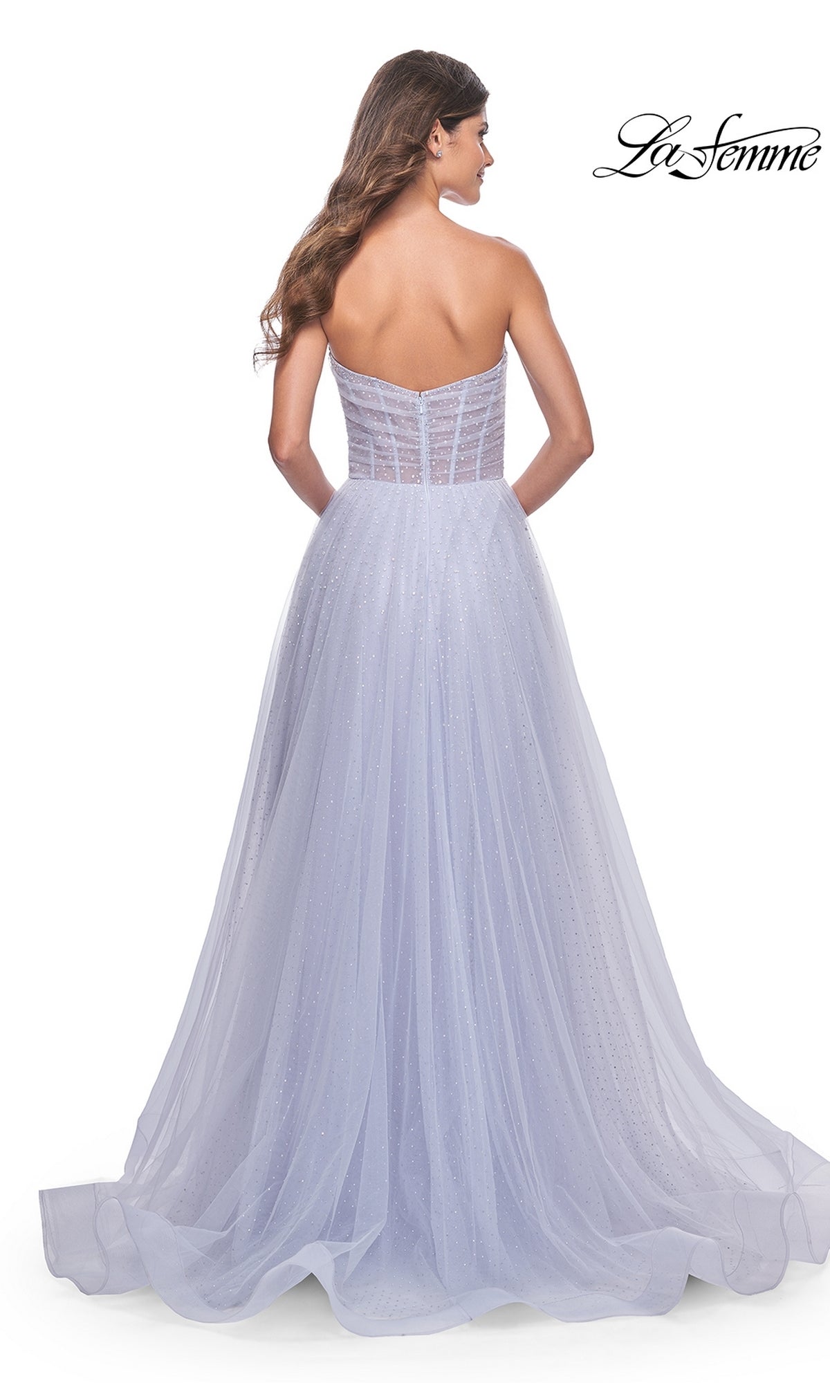 A woman with long hair is seen from the back wearing the La Femme Strapless Long Prom Ball Gown 31997 in lavender tulle, with a fitted bodice and flowing A-line skirt. The La Femme logo appears in the top right corner.