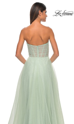 A woman is shown from the back in the La Femme Strapless Long Prom Ball Gown 31997—a mint green, a-line formal dress with a sheer embellished bodice and a flowing, floor-length tulle skirt.
