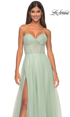 A woman wears the La Femme Strapless Long Prom Ball Gown 31997 in light green, featuring a sweetheart neckline, sheer bodice, and thigh-high slit. The La Femme logo is displayed in the top right corner.