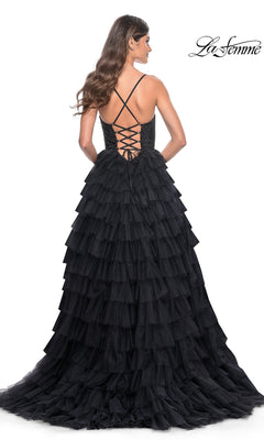 Woman wearing the La Femme Long Ruffled Prom Ball Gown 32002 with a lace-up open back, facing away from the camera.