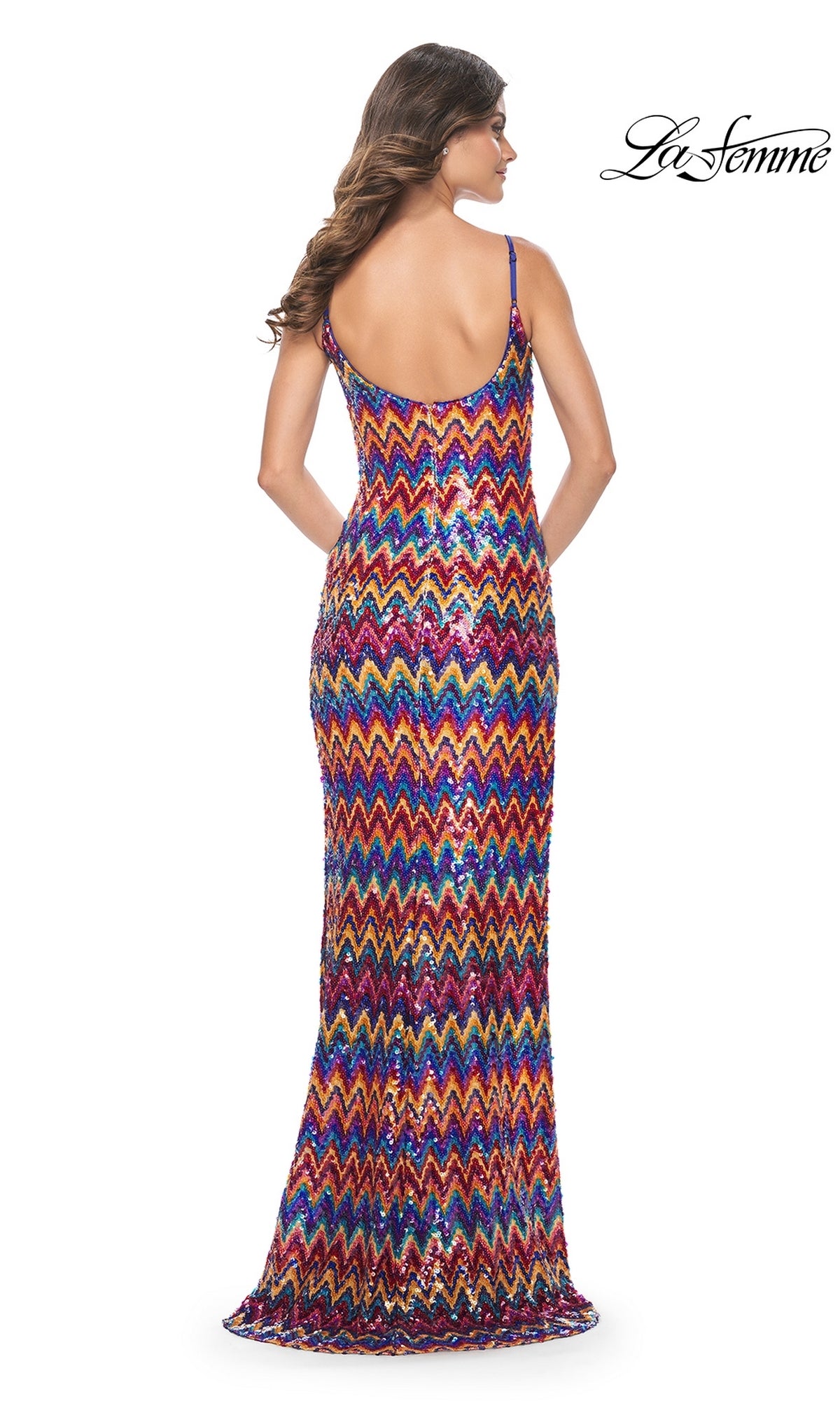 A woman faces away, wearing the La Femme Zig-Zag Long Sequin Prom Dress 32006—a sleeveless, floor-length gown with an open back and vibrant zig-zag sequins. 