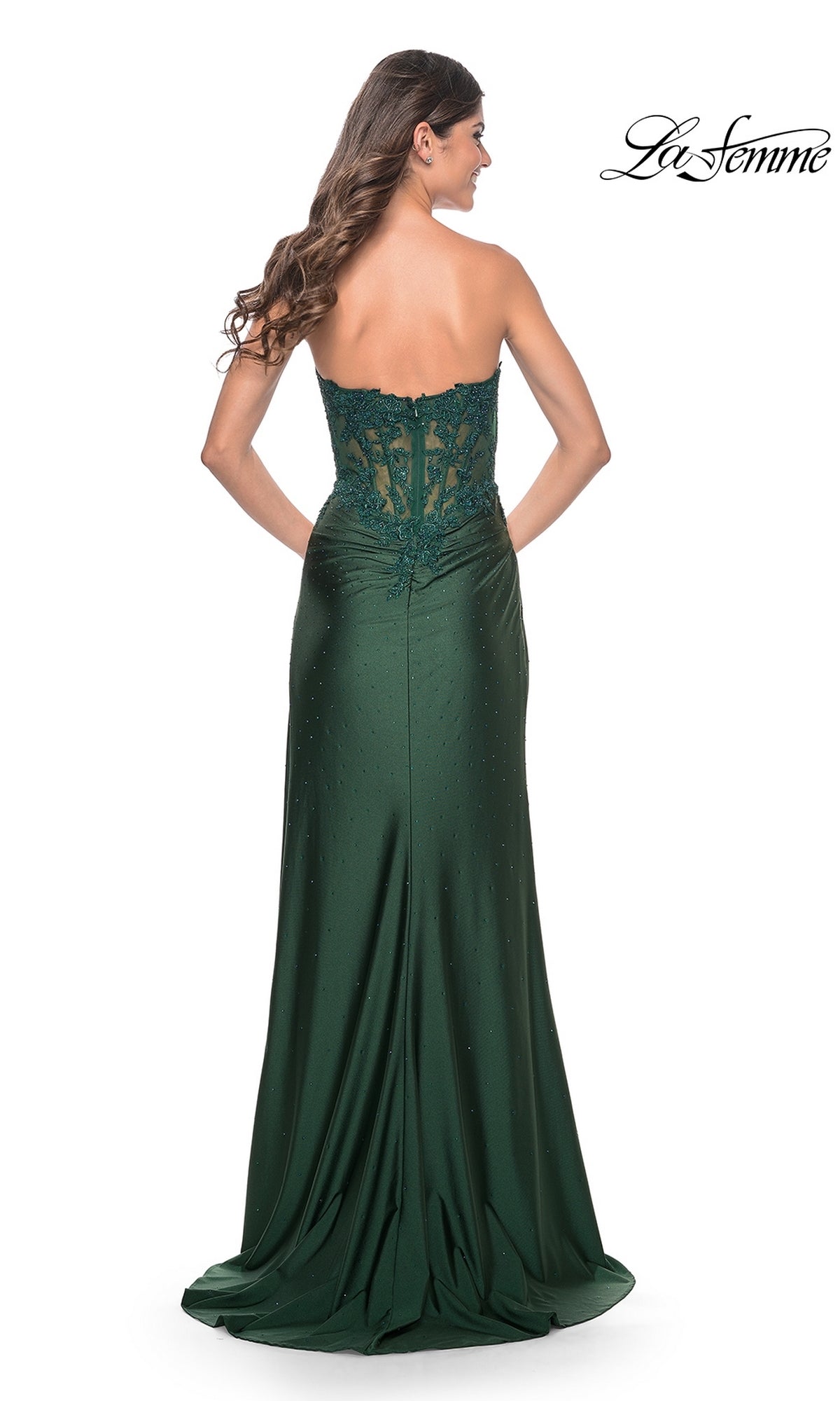 A woman faces away, wearing the La Femme Sheer-Waist Strapless Long Prom Dress 32011 in dark green with a lace-detailed back. The La Femme logo is displayed in the top right corner.