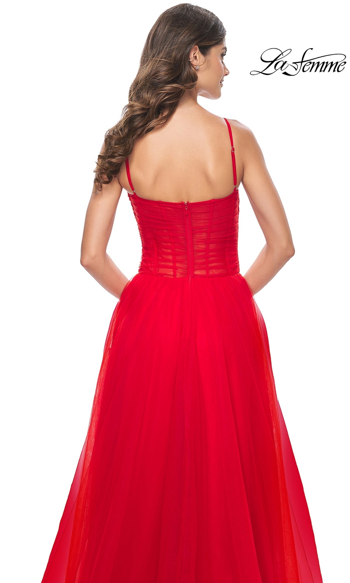 Woman with long brown hair seen from the back, wearing the La Femme Sheer-Waist Long Prom Ball Gown 32017 in red. The sleeveless, floor-length gown features thin straps, a fitted bodice, and a flowing A-line skirt.