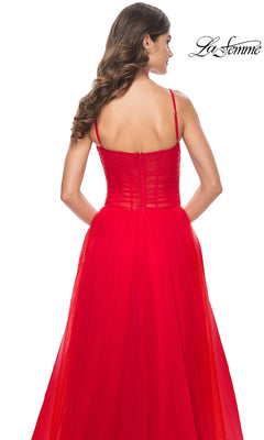 Woman with long brown hair seen from the back, wearing the La Femme Sheer-Waist Long Prom Ball Gown 32017 in red. The sleeveless, floor-length gown features thin straps, a fitted bodice, and a flowing A-line skirt.