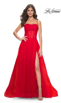 A woman stands confidently with one hand on her hip, wearing the La Femme Sheer-Waist Long Prom Ball Gown 32017—a sleeveless, floor-length A-line dress with a sheer bodice and high slit. The La Femme logo appears in the top right corner.