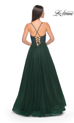 Woman in a dark green La Femme Beaded Long A-Line Prom Dress 32020 with spaghetti straps, lace-up back, subtle shimmer, and a flowing skirt, shown from behind.