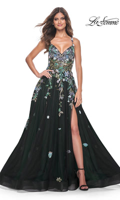A woman poses with one hand on her hip, wearing the La Femme Sequin Flower-Print Long Prom Dress 32023—black, long A-line design featuring sequin flower embroidery, thin straps, and a thigh-high slit. The "La Femme" logo is in the upper right corner.