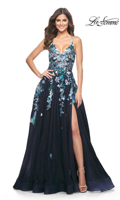 A woman wears the La Femme Sequin Flower-Print Long Prom Dress 32023, featuring navy blue sequined floral embroidery, high slit, spaghetti straps, and open-toe heels. The "La Femme" logo is shown in the upper right corner.