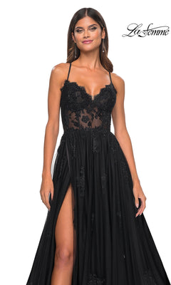 A woman models the La Femme Sheer-Corset Long A-Line Prom Dress 32028 featuring embroidered lace, spaghetti straps, a sheer bodice, high slit, and open back, against a plain white background. "La Femme" logo appears in the top right corner.
