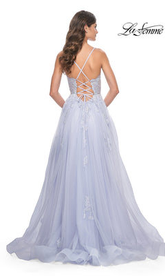 Woman in the La Femme Sheer-Corset Long A-Line Prom Dress 32028, featuring light lavender embroidered lace, an open back with crisscross straps, and a flowing tulle skirt for added elegance.