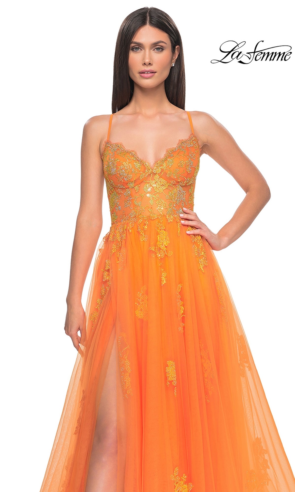 A woman models the La Femme Sheer-Corset Long A-Line Prom Dress 32028, an orange sleeveless gown with gold floral embroidery and high slit, against a white background featuring the 