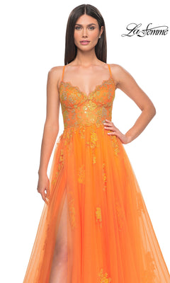 A woman models the La Femme Sheer-Corset Long A-Line Prom Dress 32028, an orange sleeveless gown with gold floral embroidery and high slit, against a white background featuring the "La Femme" logo in the top right.