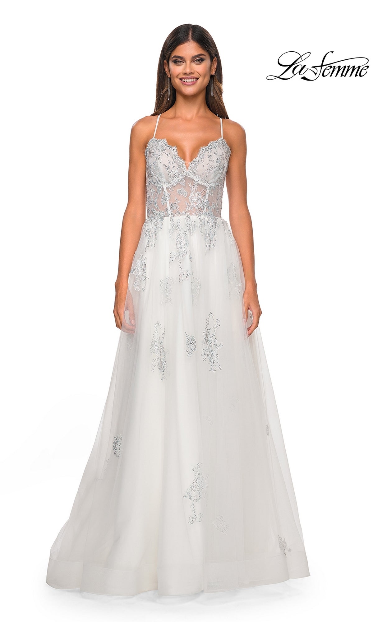 A woman stuns in the La Femme Sheer-Corset Long A-Line Prom Dress 32028, a sleeveless white gown with silver floral embroidery, sheer bodice, thin straps, flowing tulle skirt, and open back.