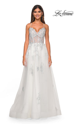 A woman stuns in the La Femme Sheer-Corset Long A-Line Prom Dress 32028, a sleeveless white gown with silver floral embroidery, sheer bodice, thin straps, flowing tulle skirt, and open back.