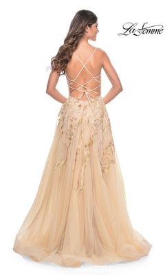 Woman in the La Femme Sequin-Lace Long A-Line Prom Dress 32032 with gold embroidery and crisscross straps, standing and facing away from the camera.