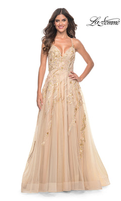 A woman in the La Femme Sequin-Lace Long A-Line Prom Dress 32032, a beige floor-length sleeveless gown with gold embroidery, stands smiling against a white background. The La Femme logo appears in the top right corner.