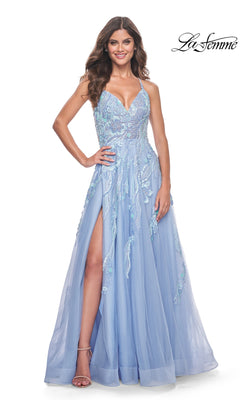 A woman in a Cloud Blue La Femme Sequin-Lace Long A-Line Prom Dress 32032 with a thigh-high slit stands smiling, one hand on her hip.