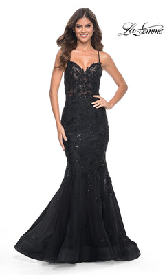 A woman poses and smiles in the La Femme Tonal Lace Long Mermaid Prom Dress 32033— a fitted black gown with beaded lace and sequin details—against a white background. The La Femme logo is visible in the top right corner.