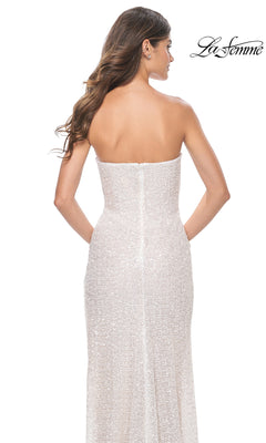 A woman with long wavy hair models the La Femme Strapless Long White Prom Dress 32045, shown from the back against a white background.