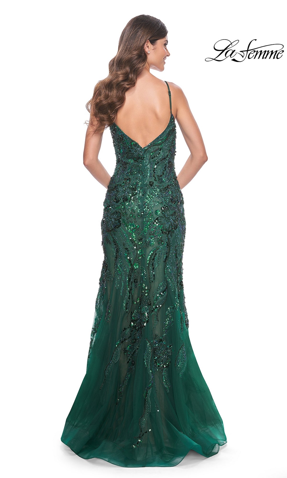 A woman in the Le Femme Sequin-Lace Long Mermaid Prom Dress 32049, featuring a stunning green sequin-lace design.