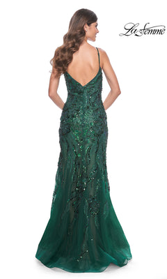 A woman in the Le Femme Sequin-Lace Long Mermaid Prom Dress 32049, featuring a stunning green sequin-lace design.