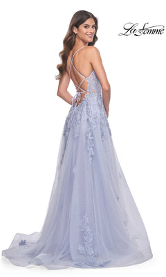 Woman wearing the La Femme Embroidered-Lace Long Prom Dress 32062 in light lavender, featuring a low back with crisscross straps, floral embroidery, and a flowing skirt as she smiles over her shoulder.