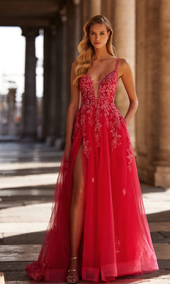 A woman in the La Femme Embroidered-Lace Long Prom Dress 32062, featuring a deep neckline, lace details, and a high slit, stands on a stone walkway with columns behind her.