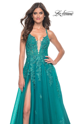 A woman models the La Femme Embroidered-Lace Long Prom Dress 32062 in teal, featuring lace details, a deep neckline, thin straps, and a thigh-high slit, posed against a plain white background.