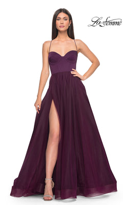 A woman wears the La Femme Long Sweetheart Prom Ball Gown 32065 in Dark Berry, featuring spaghetti straps, a sweetheart neckline, and a high slit, standing against a white background.