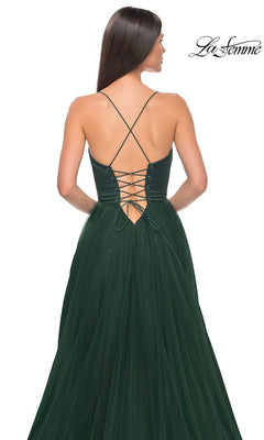 Woman wearing the La Femme Long Sweetheart Prom Ball Gown 32065 in dark green, featuring a lace-up open back, thin crisscross straps, and a flowing skirt. The La Femme logo is displayed in the top right corner.