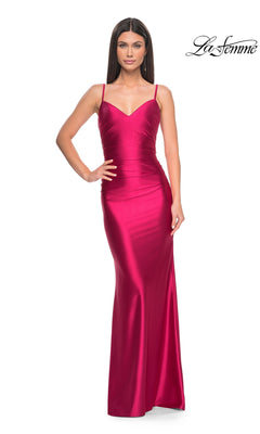 A woman stands confidently with one hand on her hip, wearing the La Femme Liquid-Jersey Tight Long Prom Dress 32075 in magenta, featuring thin straps. The La Femme logo is visible in the top right corner.