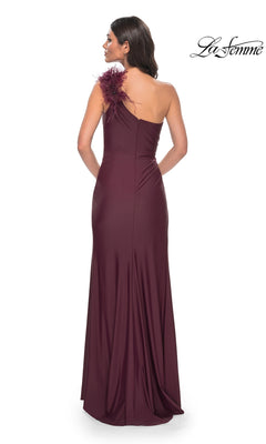 Woman shown from the back wearing the La Femme Feathered One-Shoulder Prom Dress 32076, a floor-length gown featuring a feather detail at the shoulder.