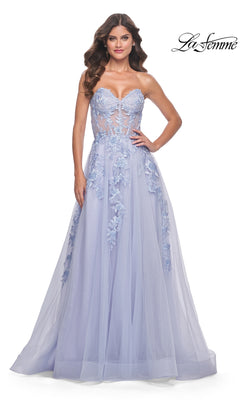 A woman poses with hands on hips in the La Femme Strapless Long A-Line Corset Prom Dress 32082, featuring lavender floral lace appliqué and a sheer bodice. The La Femme logo appears in the upper right corner.