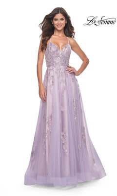 A woman stands smiling in the La Femme Sequin-Embroidered Long Prom Dress 32090—a lavender A-line gown with sequin embroidery and a tulle overlay.
