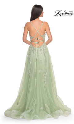 Woman wearing the La Femme Sequin-Embroidered Long Prom Dress 32090 in light green, featuring floral embellishments, sequin embroidery, and a lace-up open back, standing against a white background.