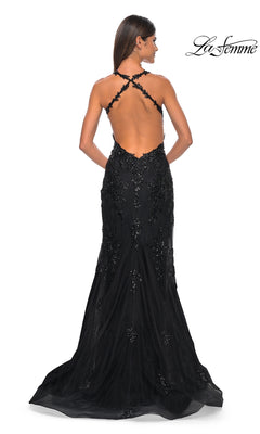 Woman in a black La Femme Sequin-Tulle Long Prom Dress 32107 with beaded embellishments, featuring an elegant floor-length silhouette and a striking backless design, standing with her back to the camera.
