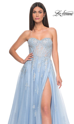 A woman models the La Femme Strapless Long A-Line Prom Dress 32111 in light blue, featuring embroidered-lace appliques, a sheer bodice, and high slit; she's standing against a white background with the "La Femme" logo.