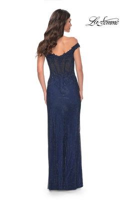 A woman is seen from behind wearing the La Femme Off-Shoulder Long Corset Prom Dress 32116 in navy, featuring a sheer corset-style bodice and lace back details. The "La Femme" logo appears in the top right corner.