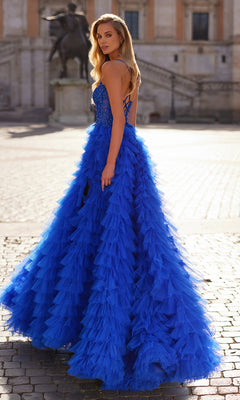 A woman stands outdoors wearing the La Femme Long Ruffled Prom Ball Gown 32128, featuring a bright royal blue hue, a fitted bodice, and a voluminous tiered skirt.
