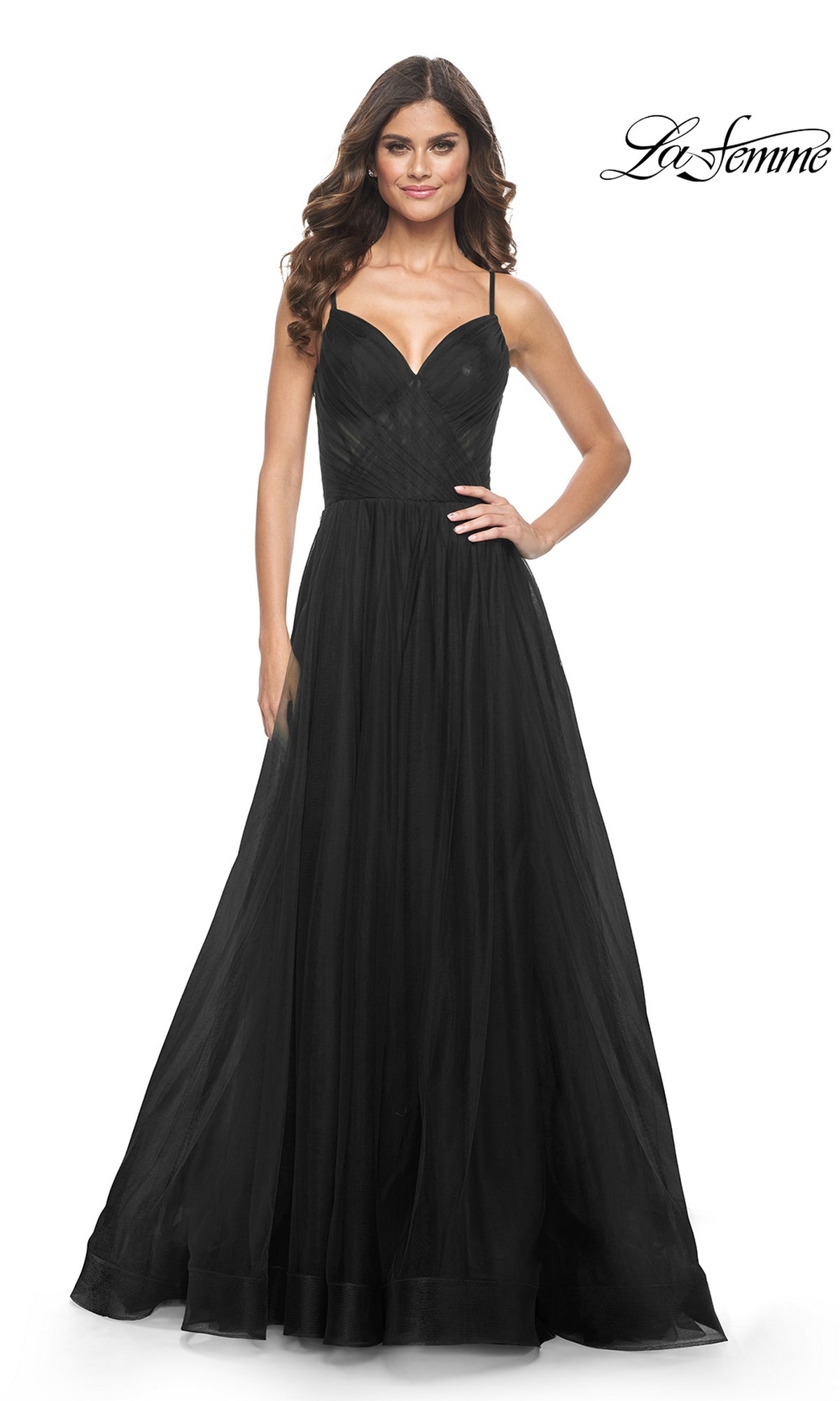 A woman in the La Femme Sheer-Waist Long A-Line Prom Dress 32130 stands and smiles against a white background. The fitted bodice, sheer waist, and flowing skirt create an elegant look ideal for special occasions.