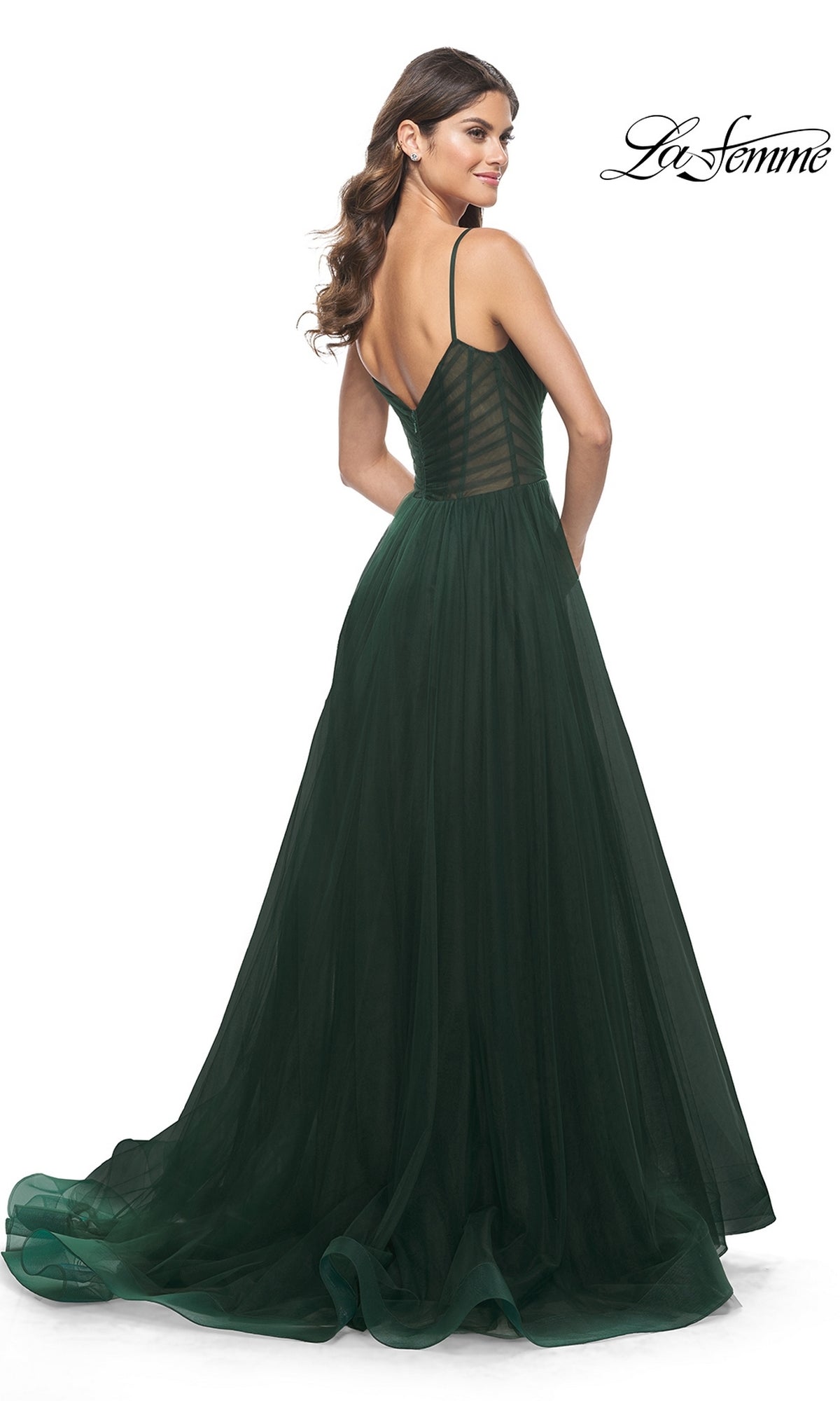 Woman facing away in a floor-length La Femme Sheer-Waist Long A-Line Prom Dress 32130, featuring thin straps, low back, fitted bodice, and flowing tulle skirt for an elegant prom look.