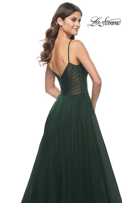 Woman in a dark green, sleeveless La Femme Sheer-Waist Long A-Line Prom Dress 32130 with a sheer, striped bodice and flowing skirt, shown from the back.