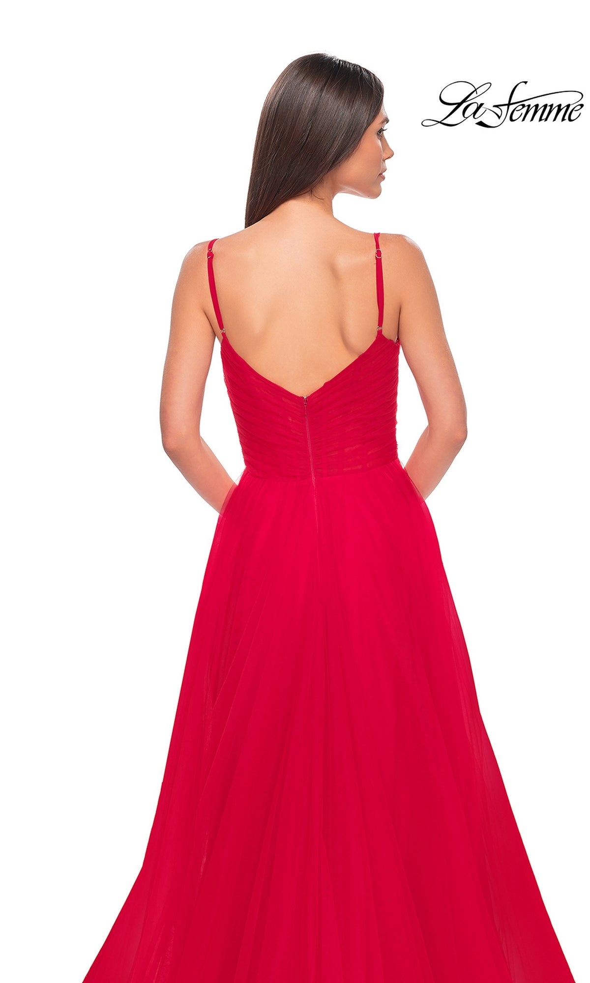 Woman in a floor-length, bright red La Femme Sheer-Waist Long A-Line Prom Dress 32130 with spaghetti straps, featuring a fitted bodice and flared skirt, photographed from the back against a white background.
