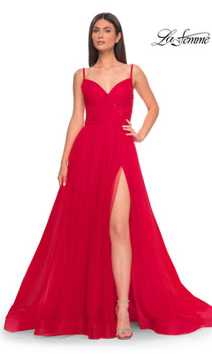 A woman models the La Femme Sheer-Waist Long A-Line Prom Dress 32130 in red, featuring spaghetti straps and a high side slit, standing against a plain white background with the La Femme logo in the corner.