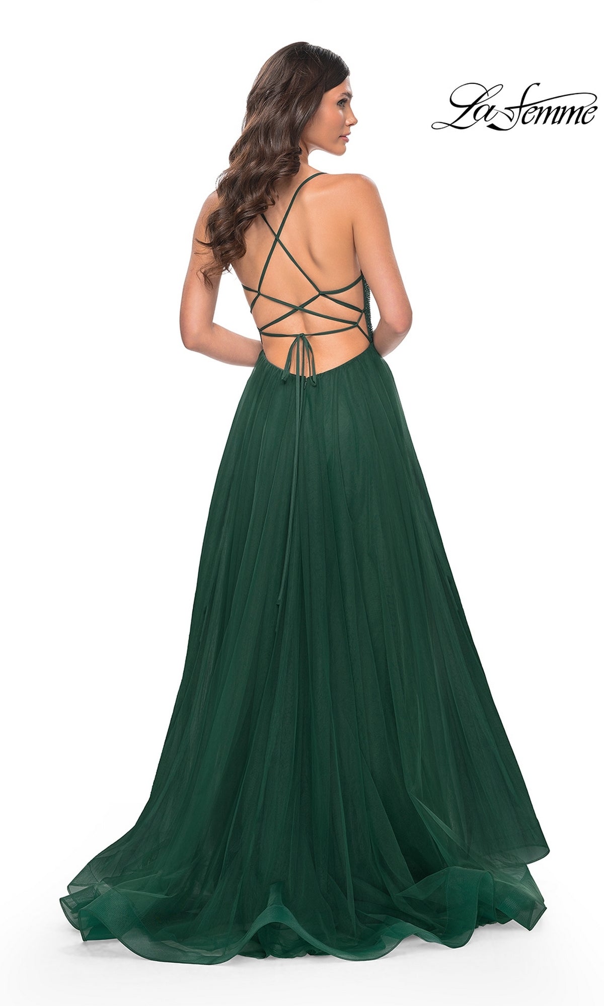 Woman wearing the La Femme Embellished Long Tulle Prom Dress 32135 in dark green, showcasing an open back with crisscrossed straps and a flowing floor-length skirt, viewed from behind.