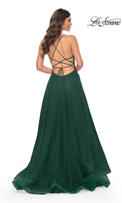 Woman wearing the La Femme Embellished Long Tulle Prom Dress 32135 in dark green, showcasing an open back with crisscrossed straps and a flowing floor-length skirt, viewed from behind.
