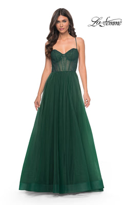 Woman wearing the La Femme Embellished Long Tulle Prom Dress 32135 in dark green, featuring a sheer bodice, spaghetti straps, and a full A-line skirt. "La Femme" logo appears in the top right corner.